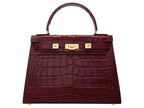 A large wine ‘croc’ print Italian calf leather handbag with top handle, detachable strap and gold plated hardware with magnetic fastening.