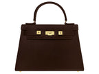 A large brown Italian leather, natural print handbag with gold hardware, a top handle with a detachable strap on a white background.