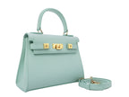 A medium-sized luxury Italian leather handbag in a soft aqua pale turquoise color with a grainy texture, featuring a top handle, a detachable shoulder strap and gold-plated hardware On a white background