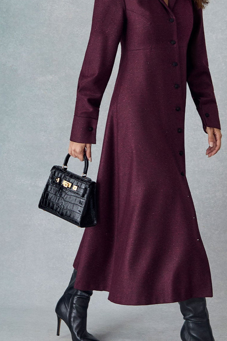 Lalage Beaumont Eleanor dress in burgundy donegal tweed with maya midi black orinoco, model shoot side