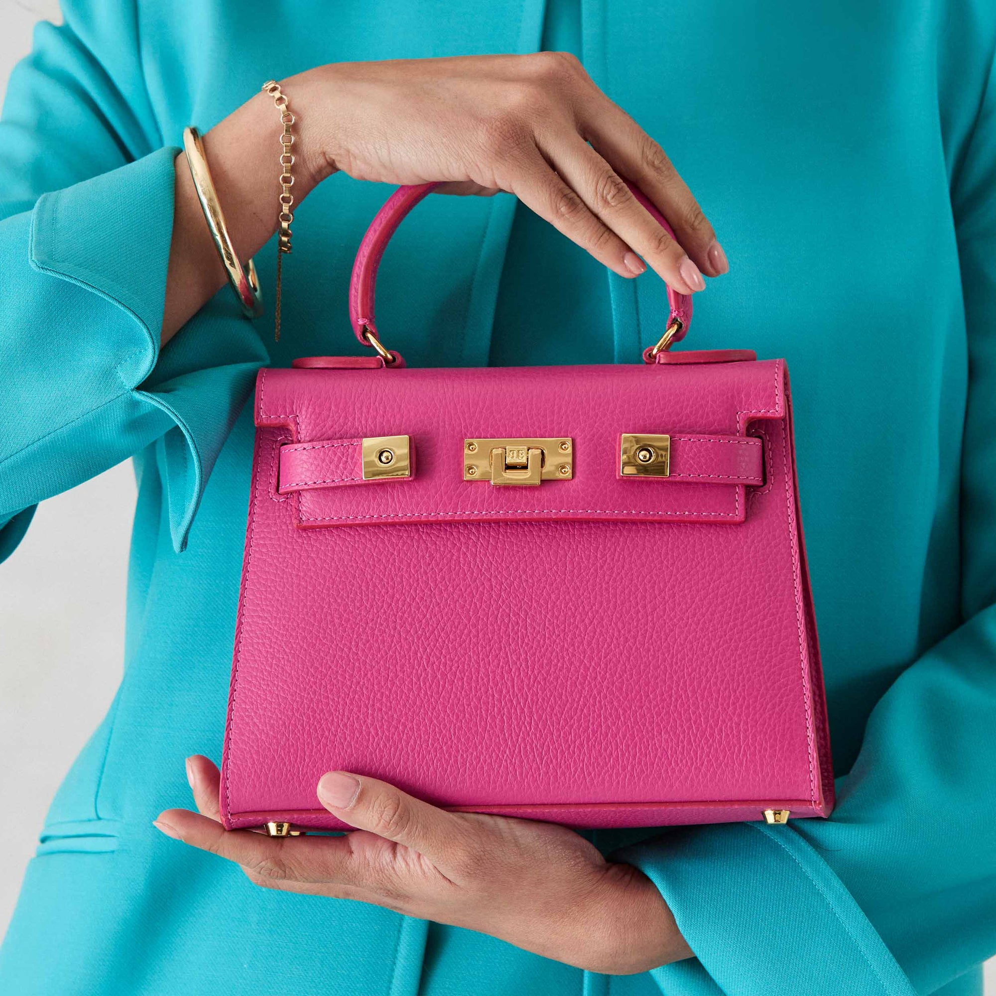 Pink elegant Maya handbags handcrafted in Italy and Spain with calf leather, suede lining, and detachable shoulder strap and gold hardware