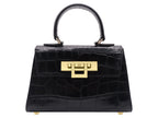 A black 'Croc' print Italian calf leather handbag with gold plated hardware and a top handle.