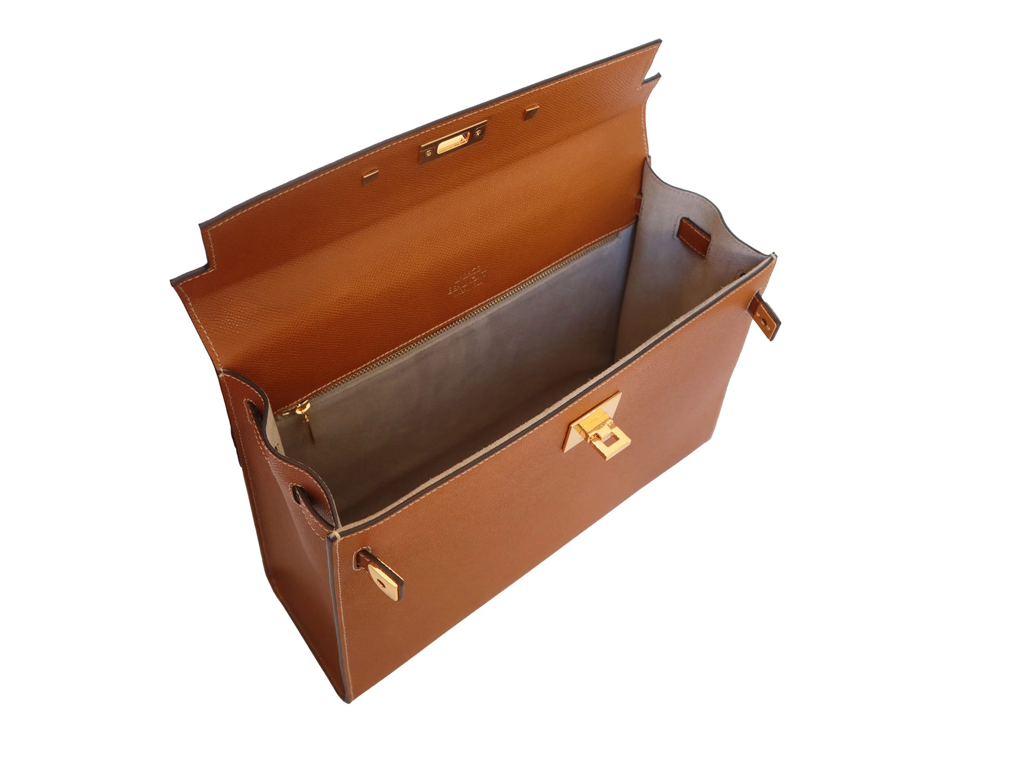 Inside of a large tan colored Italian calf leather handbag with pebble print texture, gold plated hardware, and a top handle with a detachable strap.