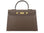 A large taupe colored Italian calf leather handbag with pebble print texture, gold plated hardware, and a top handle with a detachable strap.