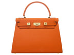 A large orange, natural grainy print Italian calf leather handbag with top handle, detachable strap and gold plated hardware.