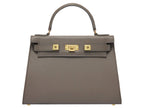 A large taupe coloured, natural grainy print Italian calf leather handbag with top handle, detachable strap and gold plated hardware.