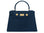 A large navy Italian leather, natural print handbag with gold hardware, a top handle with a detachable strap on a white background.