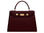 A wine-colored, pebble print Italian calf leather handbag with gold plated hardware, top handle and detachable strap in a structured design.