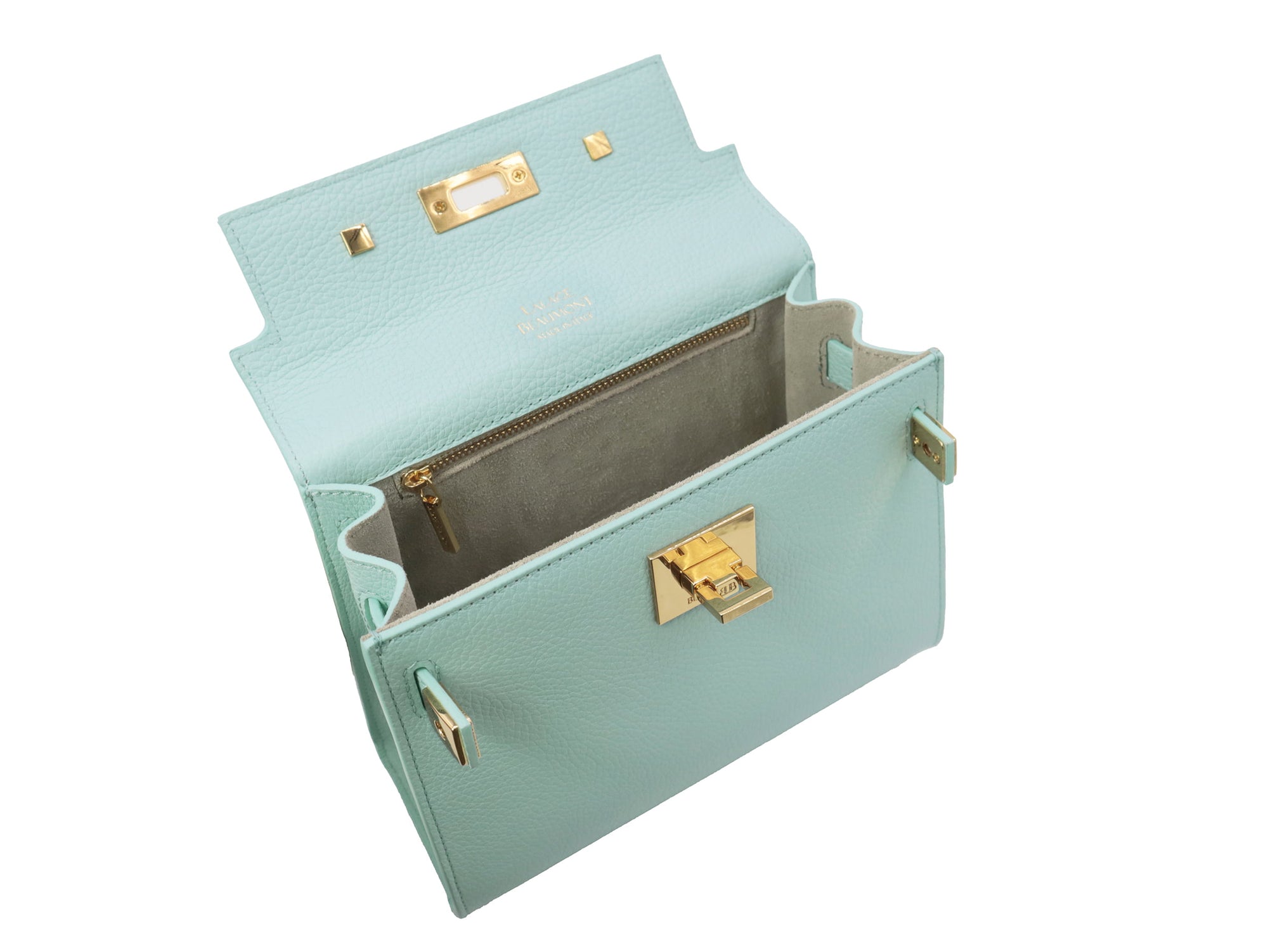 Inside view of a medium-sized luxury Italian leather handbag in a soft aqua pale turquoise color with a grainy texture, featuring a top handle, a detachable shoulder strap and gold-plated hardware