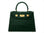 Green ‘croc’ print handbag with gold hardware on a white background