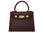 Medium chocolate brown Italian leather handbag with gold hardware, a top handle and a detachable strap on a white background
