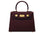 A burgundy wine coloured, medium-sized Italian leather handbag with a pebble print and gold plated hardware, featuring a top handle and a detachable shoulder strap.