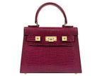 Red ‘lizard’ print Italian leather handbag with gold accents on a white background