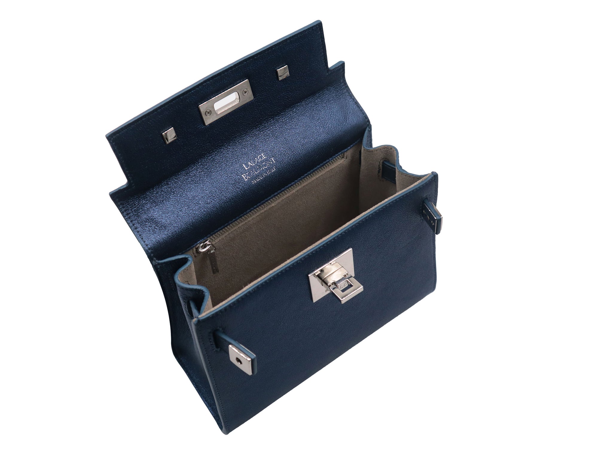 Inside view of a medium navy blue natural grain Italian leather handbag with a hint of silver sparkle  with silver hardware, a top handle and a detachable strap on a white background