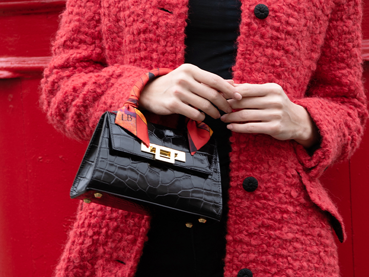 A black 'Croc' print Italian calf leather handbag with gold plated hardware and a top handle.